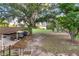 Scenic backyard featuring a boat on a trailer beneath a shady tree at 302 W Gates Ave, Lake Hamilton, FL 33851