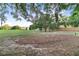 Spacious backyard with mature trees and a partially fenced perimeter at 302 W Gates Ave, Lake Hamilton, FL 33851