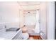 Bright bathroom features a toilet, white vanity with marble countertop, and shower/tub combo at 302 W Gates Ave, Lake Hamilton, FL 33851