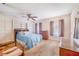 Cozy bedroom with ceiling fan, two closets, dresser, wood floors, and warm natural light at 302 W Gates Ave, Lake Hamilton, FL 33851
