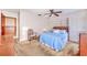 Cozy bedroom with ceiling fan, closet, dresser, and warm natural light at 302 W Gates Ave, Lake Hamilton, FL 33851