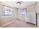 A bright bedroom with wood paneling, two windows, pink carpet and a dresser at 302 W Gates Ave, Lake Hamilton, FL 33851