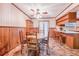 Charming dining area features a ceiling fan, wood furniture, a china cabinet, and a breakfast bar at 302 W Gates Ave, Lake Hamilton, FL 33851