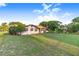 Quaint single-story home with a well-manicured lawn and mature trees at 302 W Gates Ave, Lake Hamilton, FL 33851