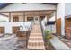 Inviting home entrance featuring a staircase leading to a covered porch and a wreath on the front door at 302 W Gates Ave, Lake Hamilton, FL 33851