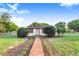 Charming home featuring a brick walkway leading to the entrance, and a well-manicured front yard at 302 W Gates Ave, Lake Hamilton, FL 33851