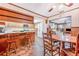 This kitchen boasts a breakfast bar, wood cabinets, a ceiling fan and seamless connectivity to the living areas at 302 W Gates Ave, Lake Hamilton, FL 33851