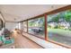 Long open porch featuring tile floors, seating, and wood pillars at 302 W Gates Ave, Lake Hamilton, FL 33851