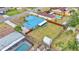 Overhead angle showing the blue metal roof, large backyard, shed and covered patio at 317 Oak Trl, Lakeland, FL 33813
