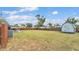 Spacious backyard featuring a shed, lush lawn, and wooden fence, offering a private retreat at 317 Oak Trl, Lakeland, FL 33813