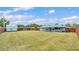 Expansive backyard featuring a large lawn, storage shed and wood privacy fence at 317 Oak Trl, Lakeland, FL 33813