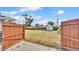 Backyard view with lush green grass, wood fence, and storage shed at 317 Oak Trl, Lakeland, FL 33813