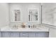 Bright bathroom features a glass shower, and double sink vanity with gray cabinetry at 317 Oak Trl, Lakeland, FL 33813