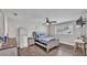 Cozy bedroom with wood floors, ceiling fan, and comfortable bed near a bright window at 317 Oak Trl, Lakeland, FL 33813