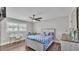 Comfortable bedroom with wood floors, natural light, a ceiling fan, and a desk area at 317 Oak Trl, Lakeland, FL 33813