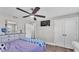 Comfortable bedroom features wood floors, ceiling fan, dresser, TV, and ample closet space at 317 Oak Trl, Lakeland, FL 33813