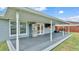 Covered patio with outdoor kitchen area, stainless steel refrigerator, and seating area for relaxation at 317 Oak Trl, Lakeland, FL 33813