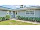 Close up front exterior shows walkway to front door, well-maintained yard, and clean, modern windows at 317 Oak Trl, Lakeland, FL 33813