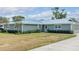 Charming single story home featuring a metal roof, mature landscaping, and a well-manicured lawn at 317 Oak Trl, Lakeland, FL 33813