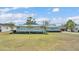 Beautiful home featuring well maintained yard and landscaping, and modern light blue metal roof at 317 Oak Trl, Lakeland, FL 33813