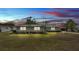 Inviting single-story home with a well-manicured lawn and exterior lighting at 317 Oak Trl, Lakeland, FL 33813