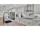 Updated kitchen featuring stainless steel appliances, white cabinetry, modern backsplash, and large island with dark countertop at 317 Oak Trl, Lakeland, FL 33813