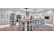 Open concept kitchen with stainless appliances, kitchen island with seating, and modern lighting at 317 Oak Trl, Lakeland, FL 33813