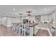 Updated kitchen featuring modern appliances, island seating, stainless appliances, and stylish decorative backsplash at 317 Oak Trl, Lakeland, FL 33813