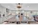 Bright kitchen features a large island with seating, white cabinetry, granite countertops, and stainless steel appliances at 317 Oak Trl, Lakeland, FL 33813