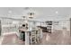 Open-concept kitchen featuring an island with sink and seating flows into the cozy living room with fireplace at 317 Oak Trl, Lakeland, FL 33813