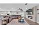 Open concept living room showcasing fireplace, flat screen TV, and access to kitchen and yard at 317 Oak Trl, Lakeland, FL 33813