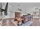 Open concept living room with fireplace, flat screen TV, and view to the kitchen and front entrance at 317 Oak Trl, Lakeland, FL 33813