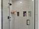 Modern shower features white subway tile, black hardware, and built-in shelving at 317 Oak Trl, Lakeland, FL 33813