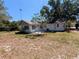 Exterior view of the home showcasing the backyard and patio area at 32 Cedar Dr, Davenport, FL 33837