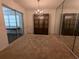 Dining room featuring carpet, ample light and mirrored accent wall at 32 Cedar Dr, Davenport, FL 33837