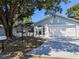 Beautiful single-story home with a painted brick facade, attached garage, and well-maintained front yard at 32 Cedar Dr, Davenport, FL 33837