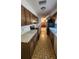 Galley kitchen featuring wood cabinetry, white countertops, and modern appliances at 32 Cedar Dr, Davenport, FL 33837