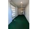 Covered porch with brick walls, a ceiling fan, and an entry door leading into the home at 32 Cedar Dr, Davenport, FL 33837