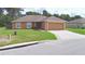 Charming single-story home featuring a well-maintained lawn, a driveway, and an attached two-car garage at 3430 Hilson Dr, Lakeland, FL 33812