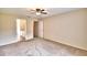 Serene main bedroom featuring plush carpeting and a doorway to an en-suite bathroom, offering privacy at 3430 Hilson Dr, Lakeland, FL 33812