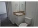 Bathroom features granite vanity with a single sink and a toilet at 3434 Avenue E Nw, Winter Haven, FL 33880