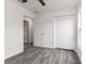 Comfortable bedroom with gray wood-look flooring, closet, and easy access to other rooms at 3434 Avenue E Nw, Winter Haven, FL 33880