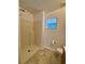 Bathroom features a walk-in shower with beige tile and a small window for natural light at 351 Columbo St, Winter Haven, FL 33880