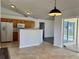 Open-concept living space featuring tile floors, a kitchen island, and sliding glass doors to pool at 351 Columbo St, Winter Haven, FL 33880