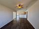 The spacious living room with high ceilings and hardwood floors has a view into the kitchen at 351 Columbo St, Winter Haven, FL 33880