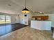 Open floorplan with tile and wood flooring, connecting the living area and kitchen for easy flow at 351 Columbo St, Winter Haven, FL 33880