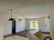 Open-concept living room with high ceilings, neutral paint, and a view of the entry door at 351 Columbo St, Winter Haven, FL 33880