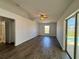 The living room features hardwood flooring, high ceilings, and sliding doors that go to the pool at 351 Columbo St, Winter Haven, FL 33880