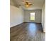 The spacious living room boasts hardwood floors and a ceiling fan for added comfort at 351 Columbo St, Winter Haven, FL 33880