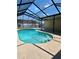 Enjoy outdoor living in this screened-in pool area, complete with a spa, patio, and ample space to relax at 351 Columbo St, Winter Haven, FL 33880